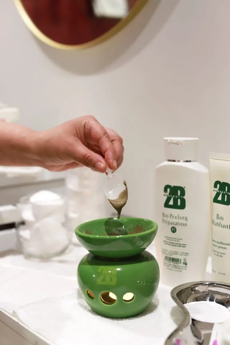 De groene kom en flesjes op de werkbank in de salon